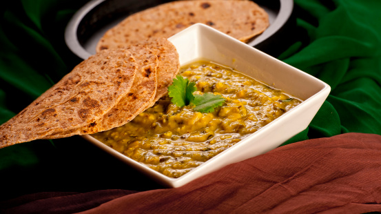 A bowl of indian dal ready to serve with roti.More like this:
