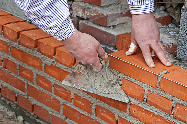 Bricklayer raising a wall stock photo