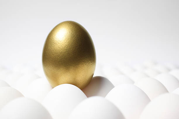istock Golden Egg Standing Out from a Crowd of Ordinary Eggs 186841957
