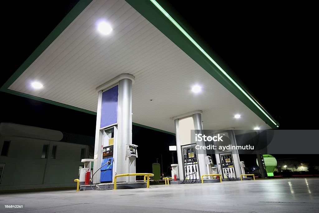 Gas station shot from below at night Illuminated Service station at night. Building Exterior Stock Photo