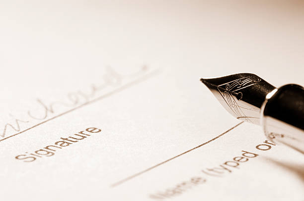istock Fountain pen ready for signature on paperwork 186842317