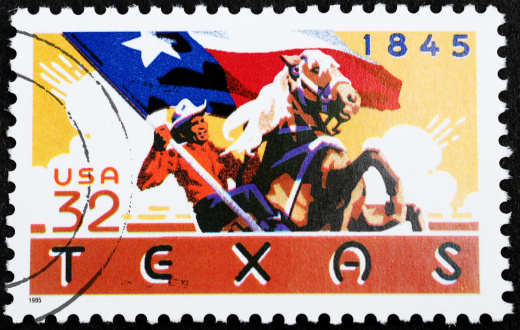 United States Postage stamp celebrating Texas statehood in 1845. Cowboy with flag riding horse. Thirty-two cent stamp issued in 1995. Circular postmark.