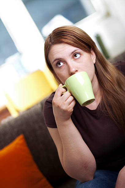istock Young woman drinking coffee 186842851
