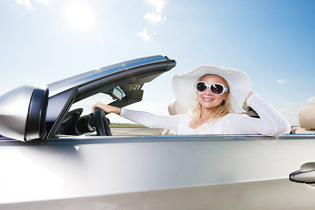 istock Happy woman driving a cabriolet car. 186843045