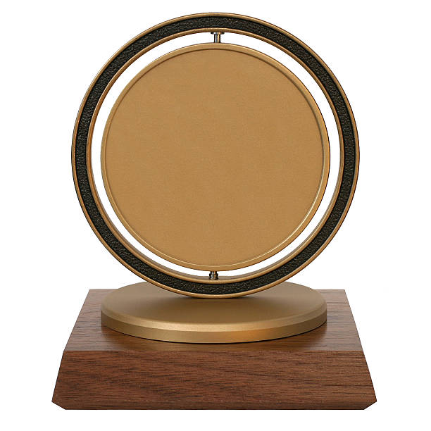 Brass corporate trophy Golden trophy on a wooden stand. Center may be used for graphic or text. Extracted. award plaque stock pictures, royalty-free photos & images