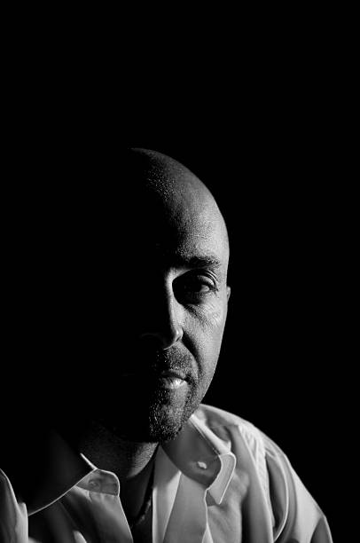 istock serious man in the dark 186843112