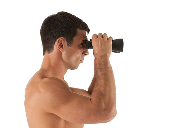 istock Profile of a man looking through binoculars 186843224