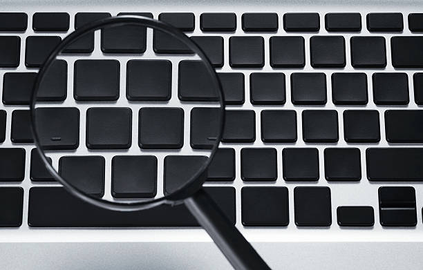 istock Blank keys on keyboard seen through magnifying glass 186843247