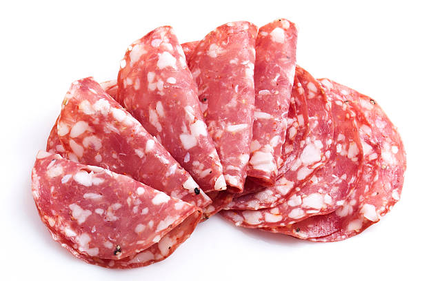 Sopressate Slices of Italian Sopressata on White Background salami stock pictures, royalty-free photos & images