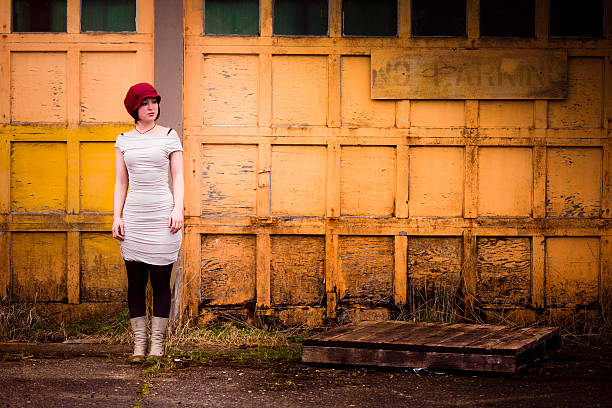 Beautiful girl in in white vintage dress with curly hair posing on the attic. Woman in retro dress. Worried sensual emotion . Retro fashion. Dramatic mood.