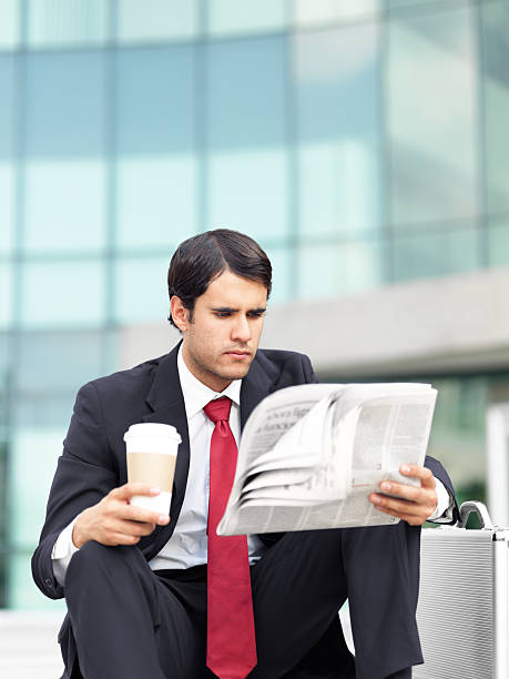 istock Young business man reading the newspaper 186843440