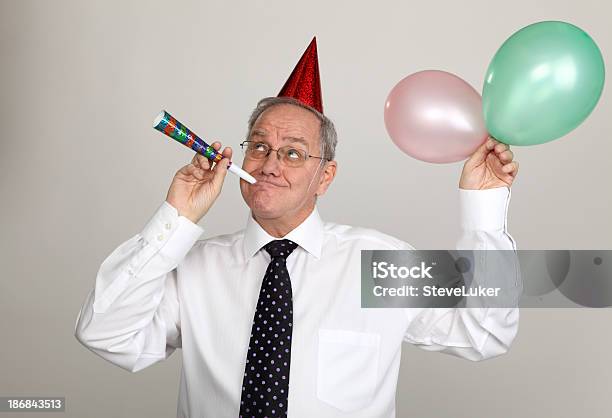 Blowing A Party Horn Stock Photo - Download Image Now - 50-59 Years, 60-69 Years, Achievement