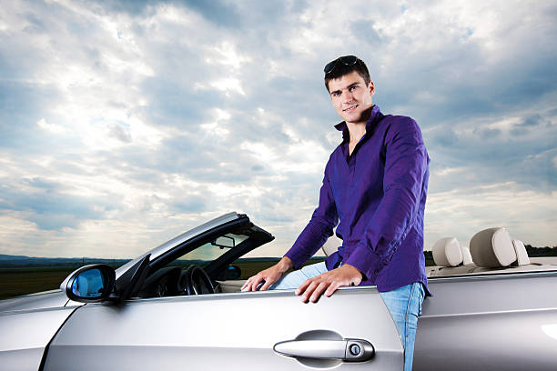 istock Young handsome man standing next to his cabriolet. 186843728