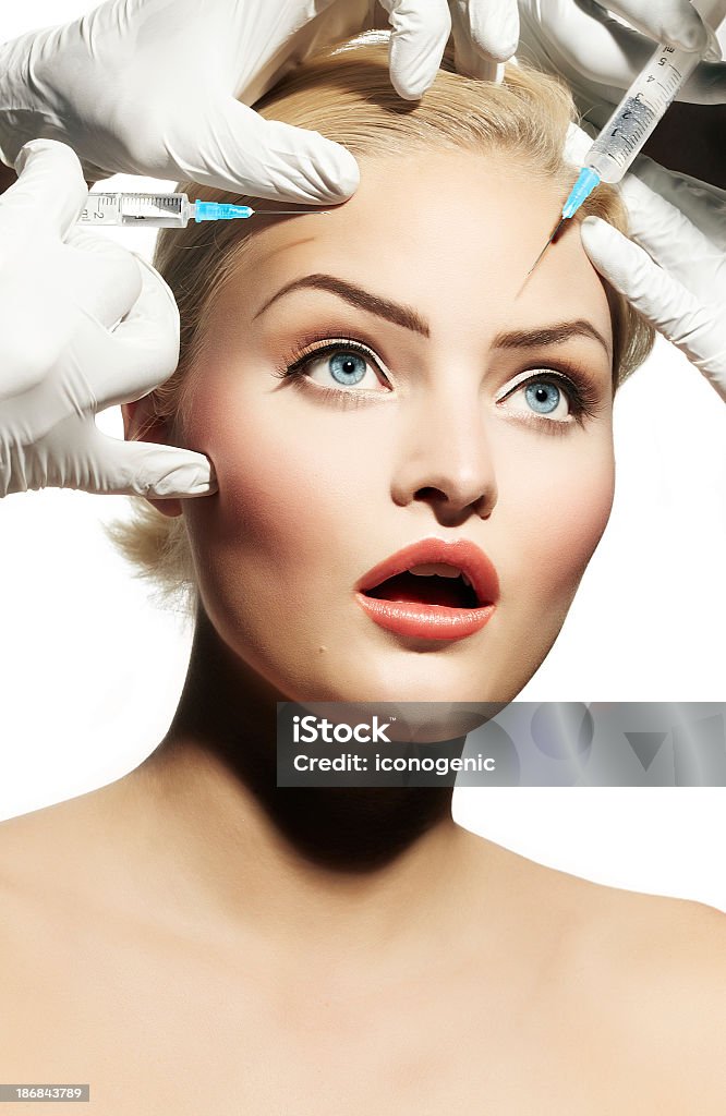 Dramatization of a blonde woman getting Botox injections Young woman getting botox. Human Face Stock Photo