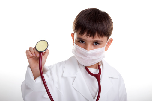 6 years old boy as a doctor isolated on white .