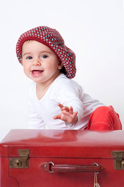istock Baby Girl playing with the suitcase. 186844569