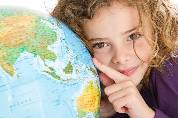 istock Cute little girl pointing at globe 186844578