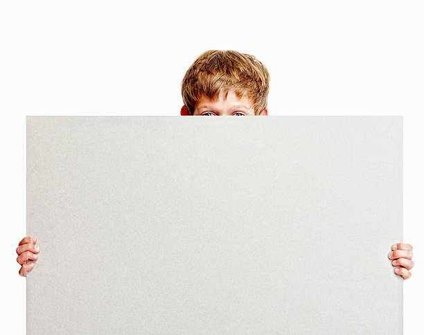 istock An isolated boy holding billboard over his face 186844805