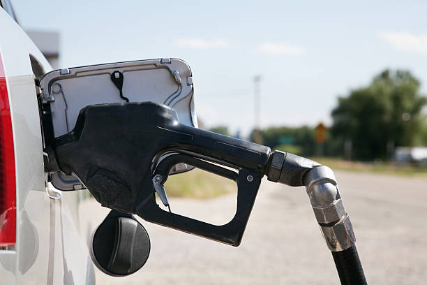 istock Gasoline lever handle pumping gas into Car 186844813