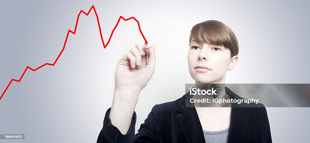 Graph of Double Dip Recession Business woman drawing a financial graph showing a double dip recession. Dipping Stock Photo