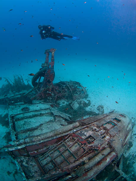 istock scuba diver on a wrecked bomber plane 186845195