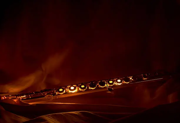 "A glowing flute, lit from within.  Sepia tones.  Framed to leave room for copy.  Would make an ideal business card, greeting card, or poster."