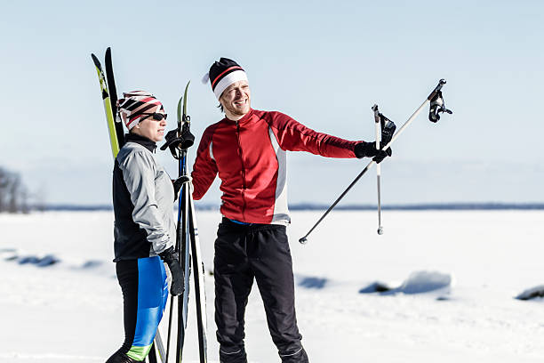 Male and female athletes cross-country skiing. stock photo
