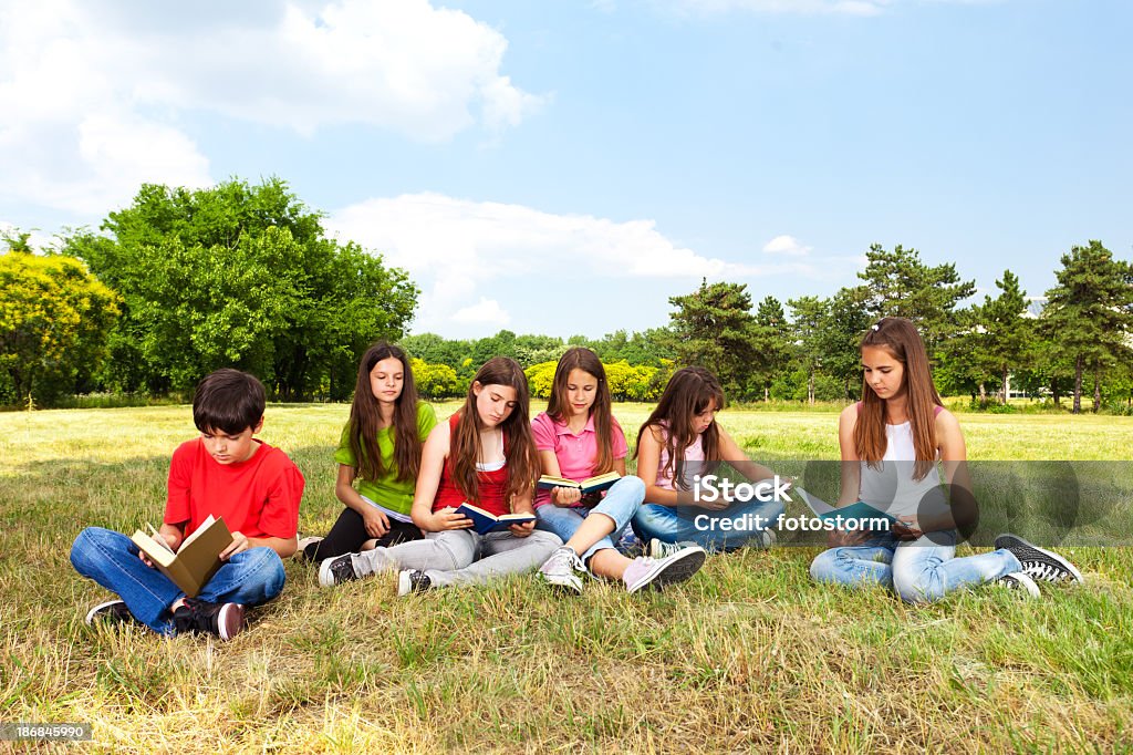 Grupo de crianças lendo o livro ao ar livre - Foto de stock de Campo royalty-free