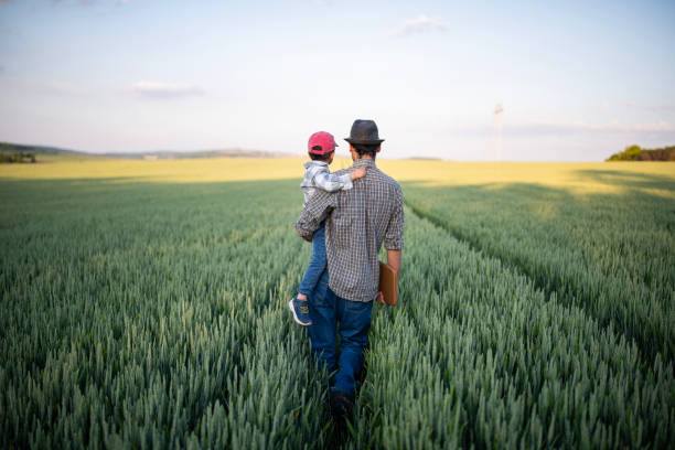 istock When I grow up I'm going to be a farmer just like daddy. 1868460904