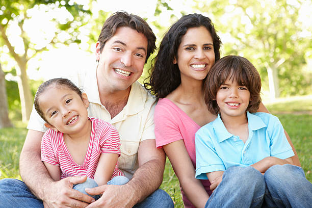 istock Young Hispanic Family Relaxing In Park 186846211