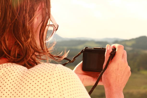 istock Woman Taking Photos with her Camera 1868464266