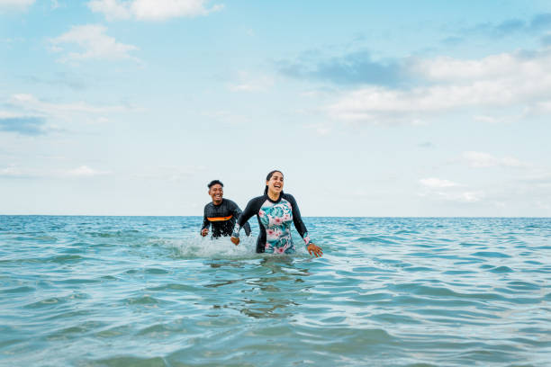 istock Young couple having fun at the beach 1868468398