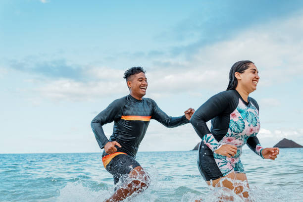 istock Young couple having fun at the beach 1868468400