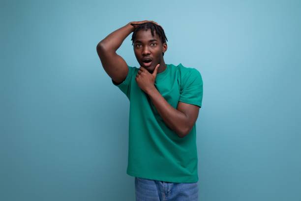 istock charming brunette model stylish african guy in a t-shirt on a blue background 1868473802