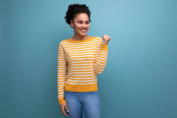 istock successful happy brunette latin young woman with ponytail smiling on studio background 1868474316