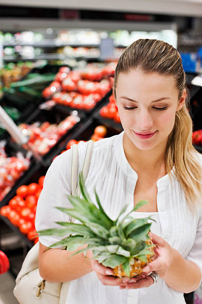 istock Woman Looking at Fruit 186847438