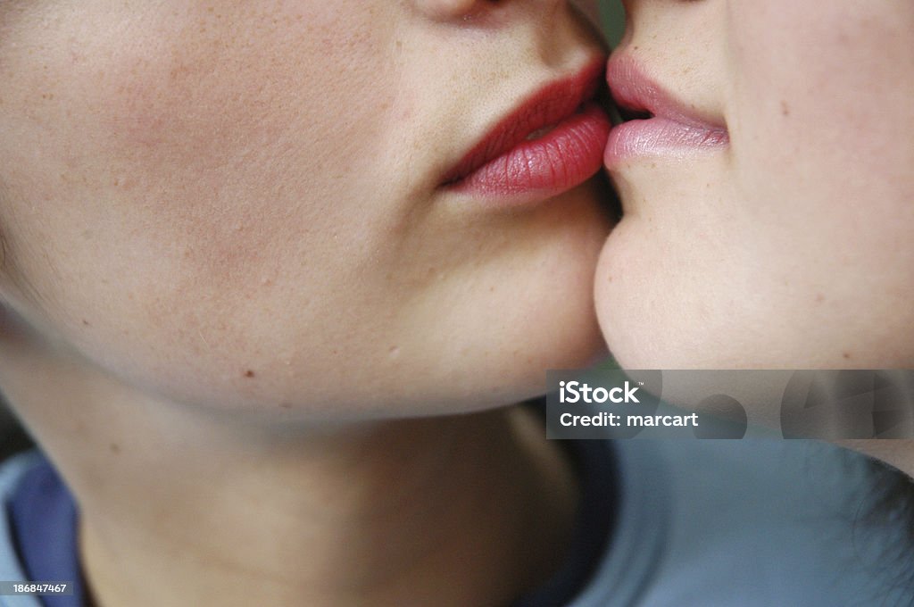 tactful kiss two kissing girls at home Adult Stock Photo