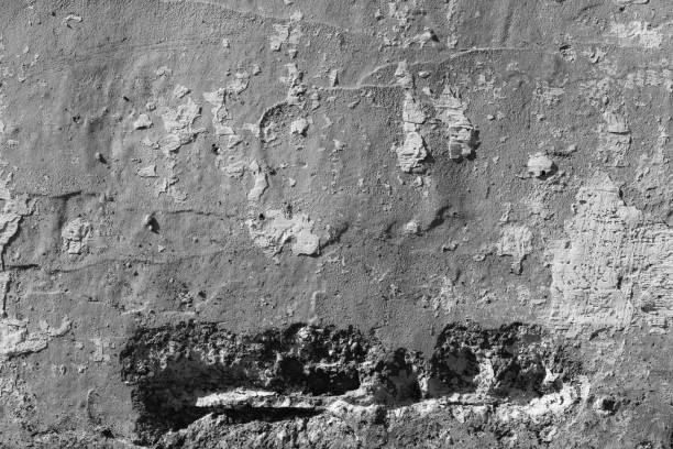 White concrete wall with deep scratches and chips. Various variations of abrasions.