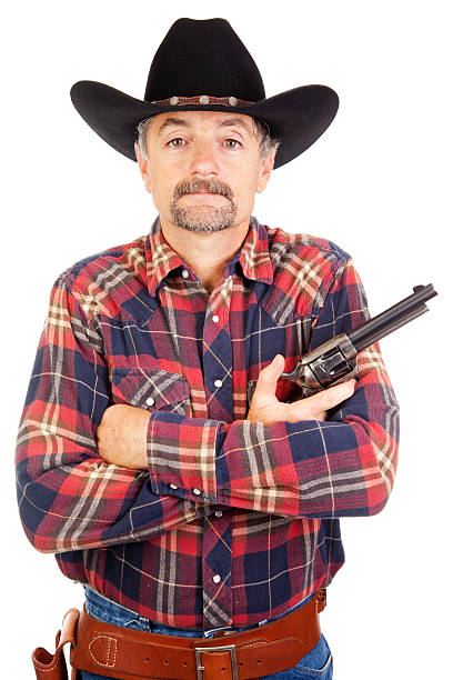 istock Cowboy with a revolver isolated on white 186847690