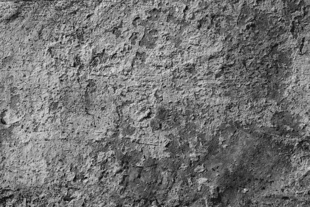 istock White concrete wall with deep scratches and chips. Various variations of abrasions. 1868479815
