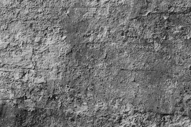 istock White concrete wall with deep scratches and chips. Various variations of abrasions. 1868479816