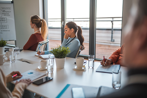 A multi-ethnic team of creative agency professionals collaborate on a project. They brainstorm and discuss ideas, fostering a dynamic and productive work environment.