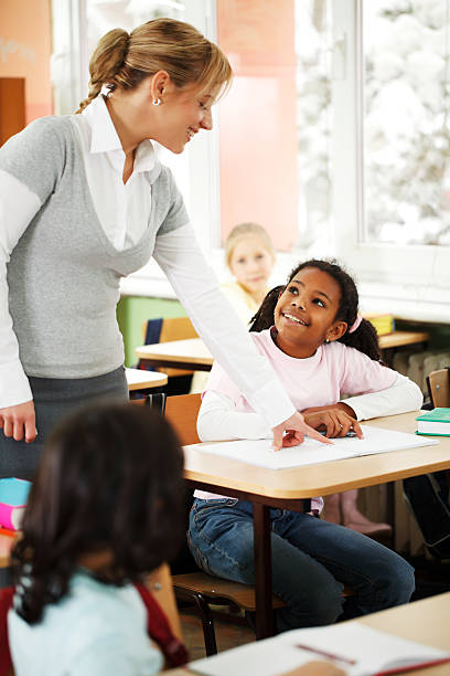 istock Teacher explains children in the classroom 186848192