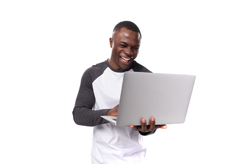 young american man dressed casually working using laptop.