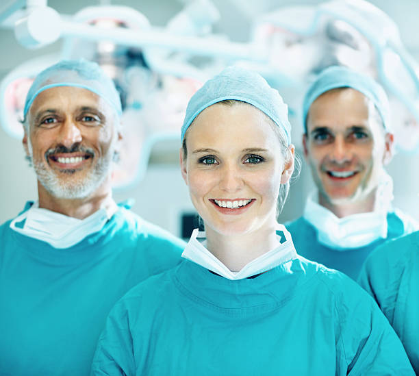 istock Female doctor smiling with team 186848465