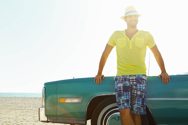 istock Smiling young man leaning on his Cadillac car 186848631