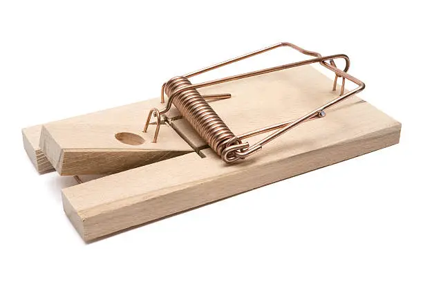 Wooden mousetrap isolated on a white background.