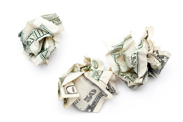 istock Crumpled Money - Large US Currency Thrown in Garbage 186849275
