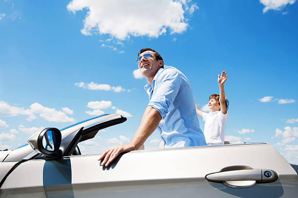 Father and son inside of the Convertible car.