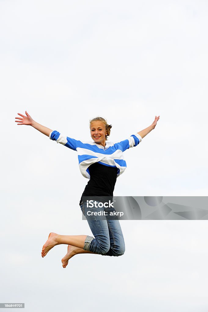 Girl Jumping for Joy Pretty teenage girl jumping high against white background. Much copy space. 16-17 Years Stock Photo